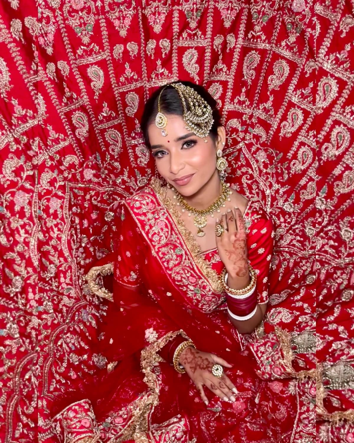 Grand Red Bridal Flare & Kaleerein — bridal makeup by Makeovers by Bhuvita, Chandigarh