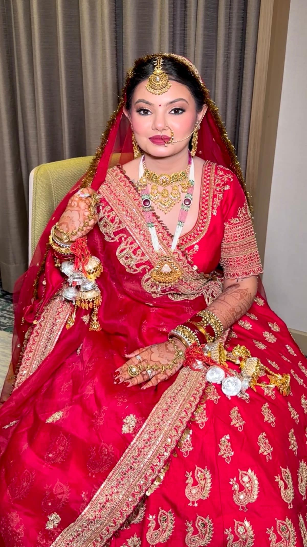 Regal Red Punjabi Bride with Full Jewels — bridal makeup by Makeovers by Bhuvita, Chandigarh